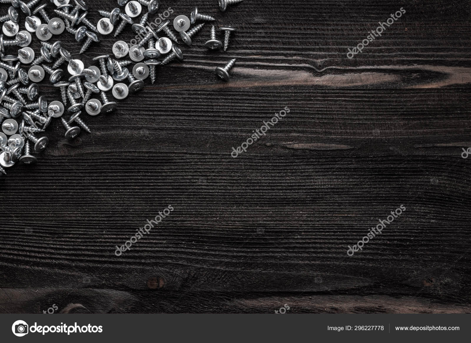 Some Wood Crews On Dark Wooden Desk Board Surface. Top View For Borderless Certificate Templates